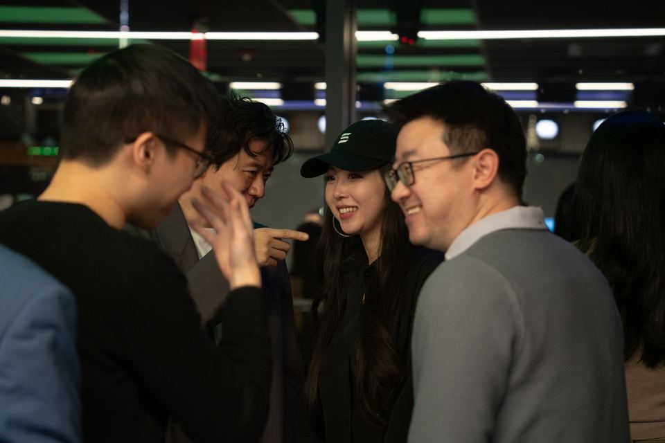 Attendees comparing notes on their phones