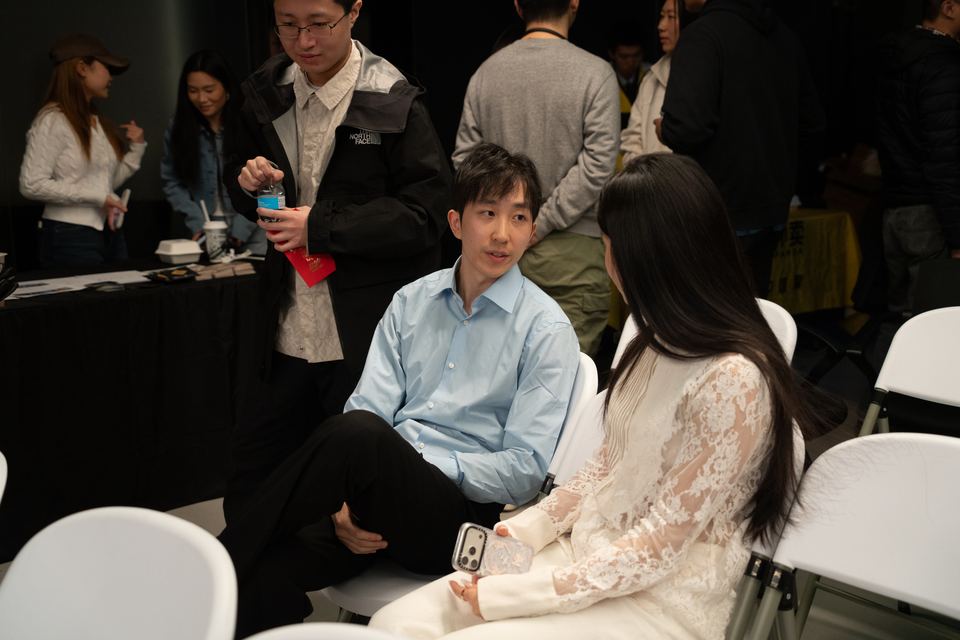 Two attendees talking in the seating area