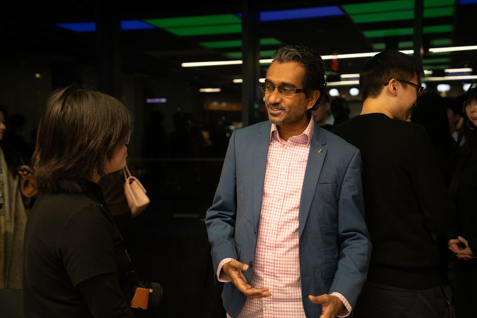 A guest speaking with attendees after the program