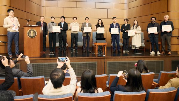 Finalist teams and judges on stage at the award ceremony